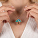 Person wearing a mushroom necklace with a colorful pendant
