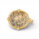 Gold ring with a dendritic quartz stone and intricate design on a white background