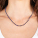 Gold chain necklace with lapis gemstones on a person