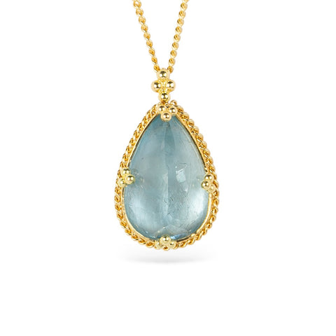 Gold necklace with a teardrop-shaped aquamarine gemstone pendant on a white background