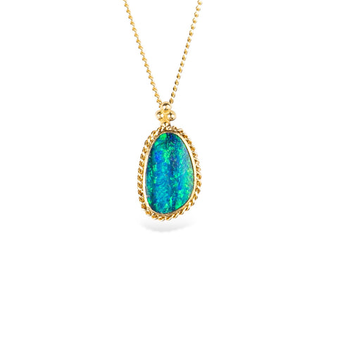 Australian opal doublet and 18k yellow gold necklace on a white background.