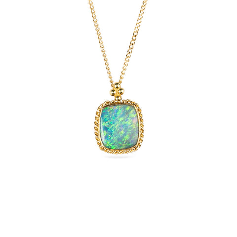 Australian opal doublet and 18k yellow gold necklace on a white background.