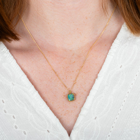 A model wears an australian opal doublet and 18k yellow gold necklace.