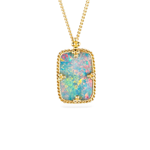 Handmade australian opal doublet and 18k yellow gold necklace on a white background.