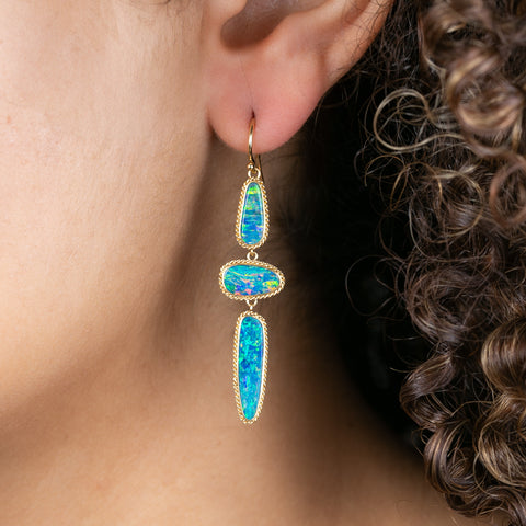 Australian opal and 18k gold earrings on model