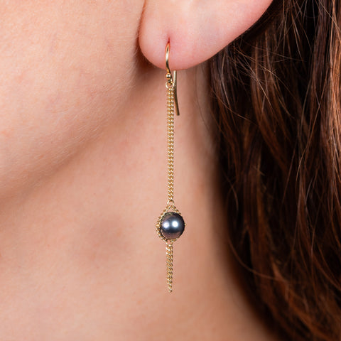 Blue akoya pearl earrings on model