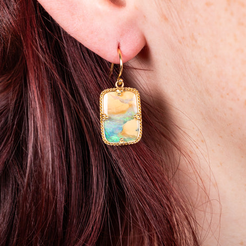 Boulder opal earrings on model