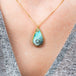 Boulder opal feather necklace on model