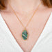 A model wears a boulder opal and 18k yellow gold necklace.