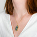 A model wears a boulder opal and 18k yellow gold necklace.