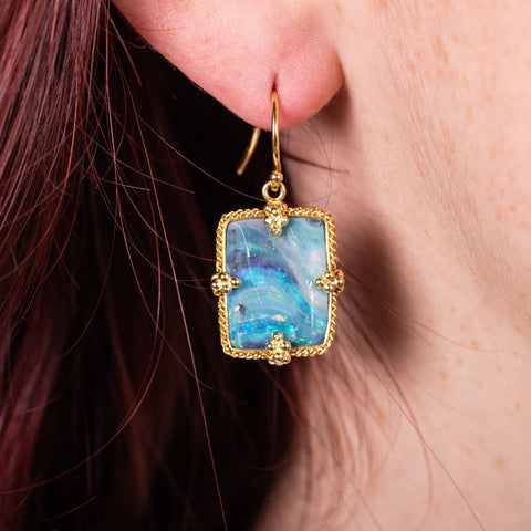 Boulder opal earrings on model