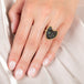 A model wears an 18k yellow gold and onyx ring shaped as a cat face.
