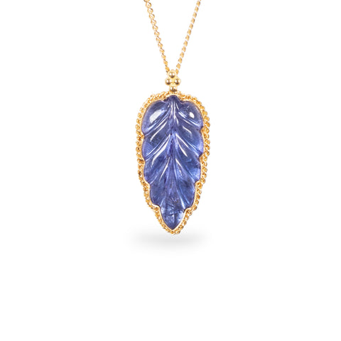 Carved tanzanite lead necklace on white background