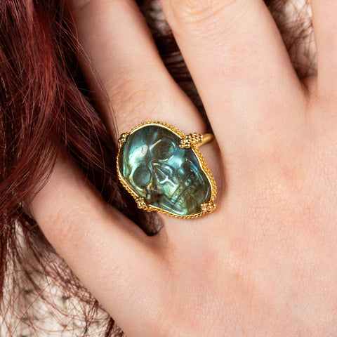 Carved labradorite skull ring on model close up