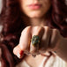Carved labradorite skull ring on model