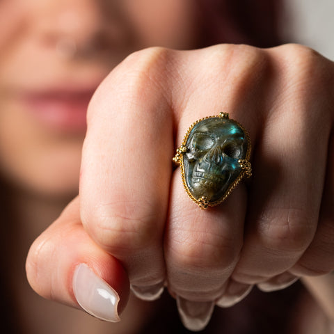 Carved labradorite skull ring on model spooky
