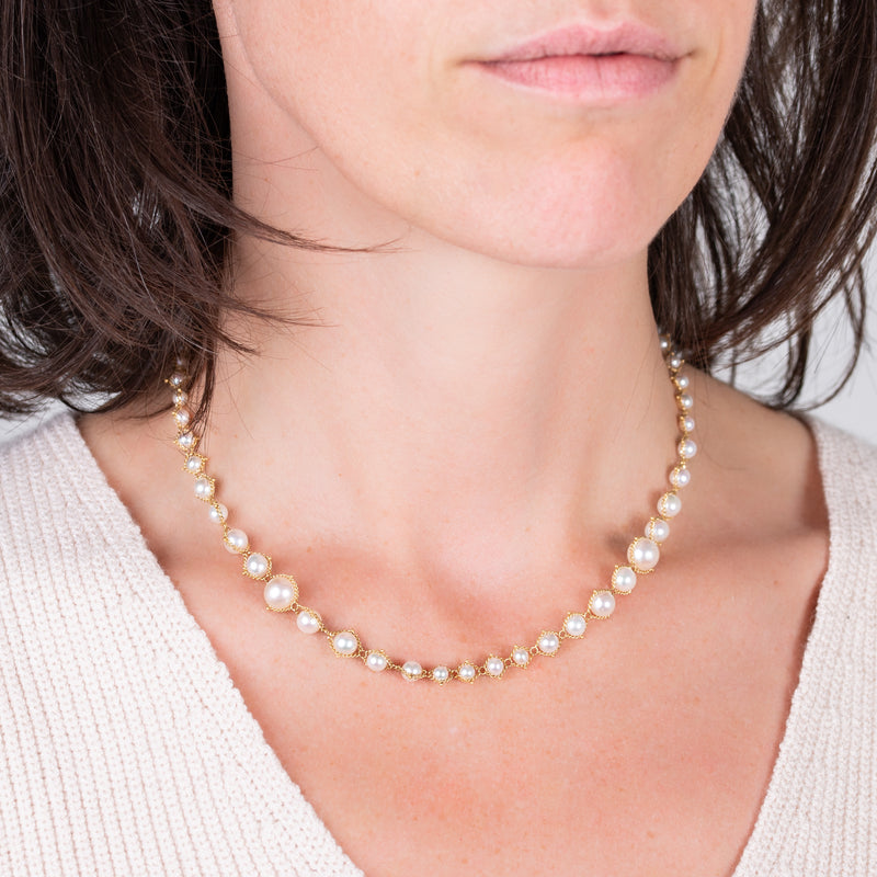 Woven cascading akoya pearl necklace on a model