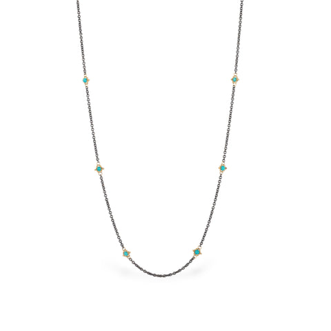 Oxidized silver chain necklace with turquoise gemstone beads encircled in 18k yellow gold.