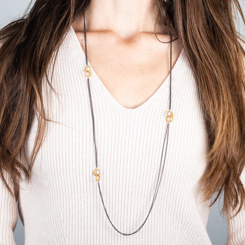 oxidized silver and gold double hoop necklace on a model