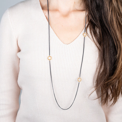 Oxidized silver and gold hoop necklace on a model