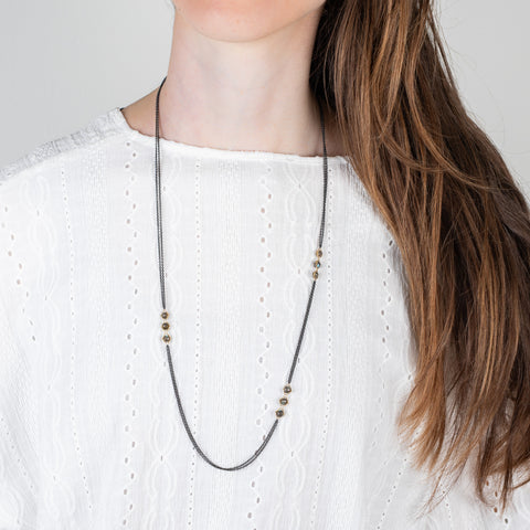 Oxidized silver and gold necklace with labradorite on a model