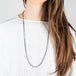 Oxidized silver and gold necklace with london blue topaz on a model