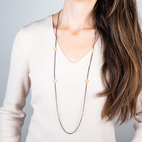 Oxidized silver and gold hoop necklace on a model