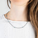 Oxidized silver and gold necklace with london blue topaz on a model
