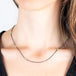A model wears an oxidized silver and 18k yellow gold chain necklace with turquoise gemstone beads.