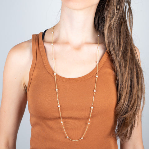 18k gold and pearl woven necklace on a model