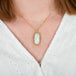 A model wearing an oval ethiopian opal and 18k yellow gold necklace.