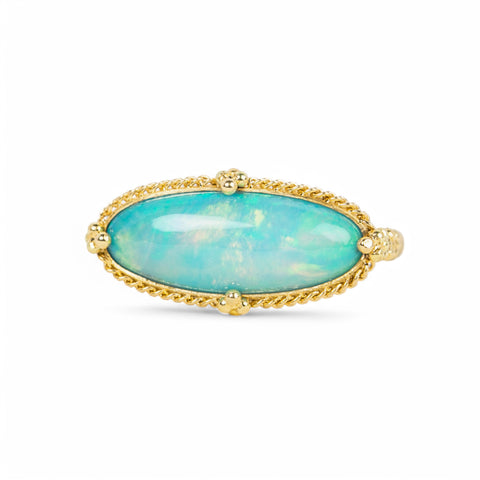 A handmade ring featuring an oval ethiopian opal gemstone in an 18k gold setting on a white background.
