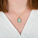 A model wears an 18k yellow gold and ethiopian opal gemstone necklace.