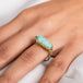 A model wears an ethiopian opal and 18k yellow gold ring.