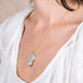 Ethiopian Opal skull necklace on a model side view