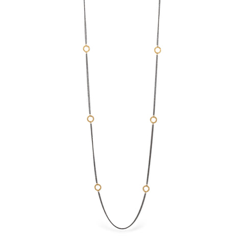 Oxidized silver necklace with 18k gold hoops on white background