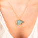 Carved aquamarine horse necklace on model
