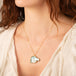 Carved aquamarine horse necklace on model side