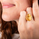 Carved citrine lion ring worn on a model