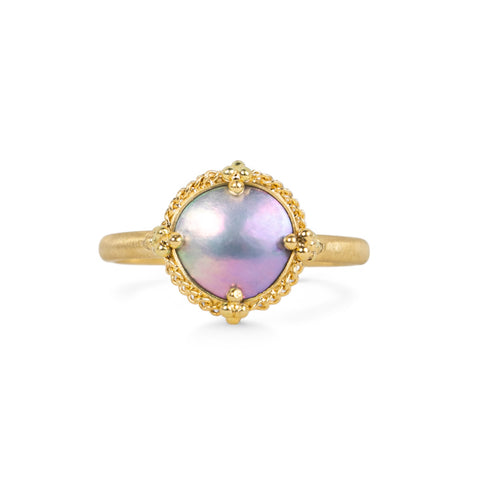 A mabe pearl ring with an 18k gold setting and band, shown against a white background.
