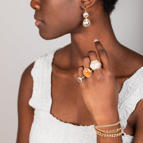 Mabe pearl earrings on model paired with rings
