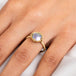 A model wears a ring featuring mabe pearl and 18k yellow gold.