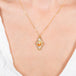 Mexican opal kite-shaped necklace on a model