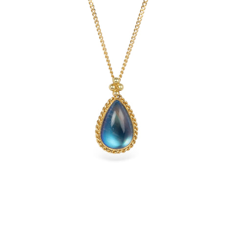 A teardrop-shaped moonstone pendant set in an 18k yellow gold bezel, suspended from a matching gold chain.