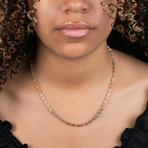 A model wears a chain necklace made of moonstone beads and 18k yellow gold chain.