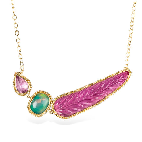 Handmade 18k yellow gold necklace featuring a ruby, ethiopian opal, and carved feather tourmaline gemstone.