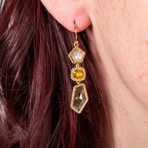Colored diamond earrings on model