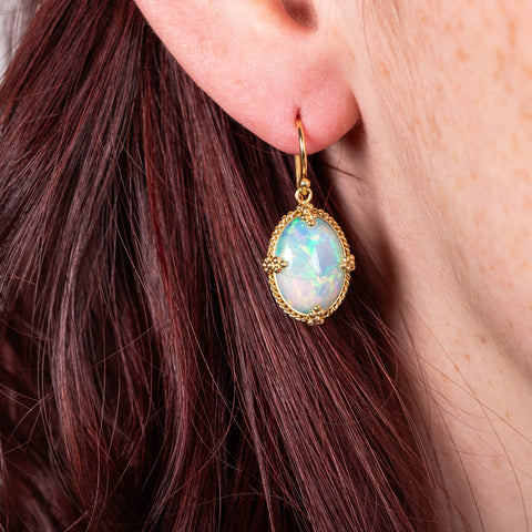 Oval Ethiopian Opal earrings on model