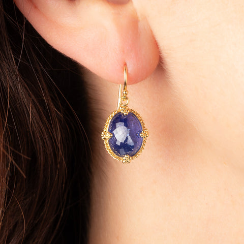 Oval tanzanite earrings on a model