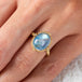 Blue moonstone and gold ring on model close up